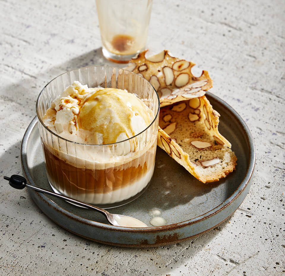 A plate with a clear dish of affogato