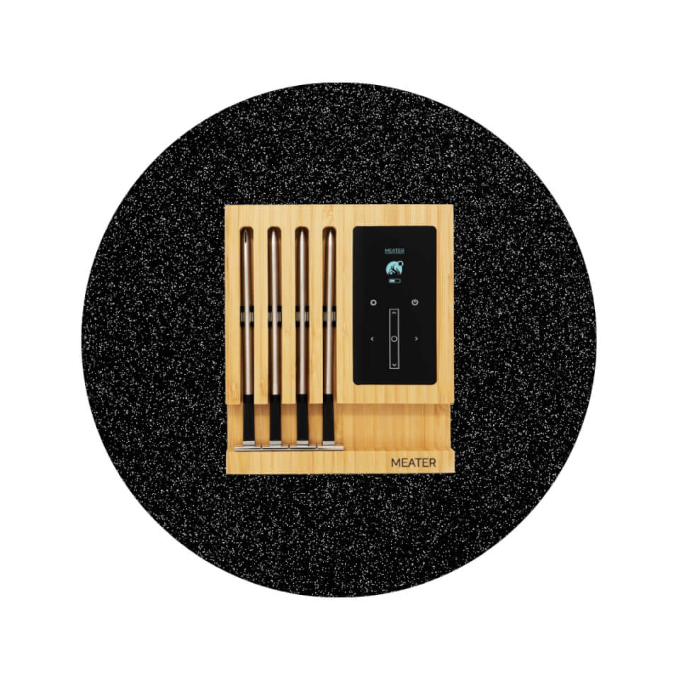 A wooden block with four thermometer probes and a touch screen in a sparkly black circle