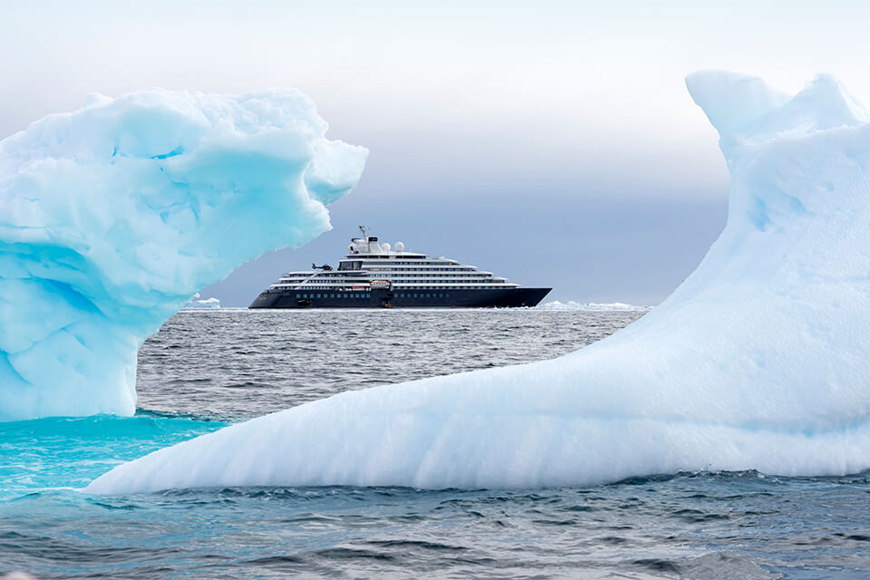 A view of a cruise ship from between ice bergs