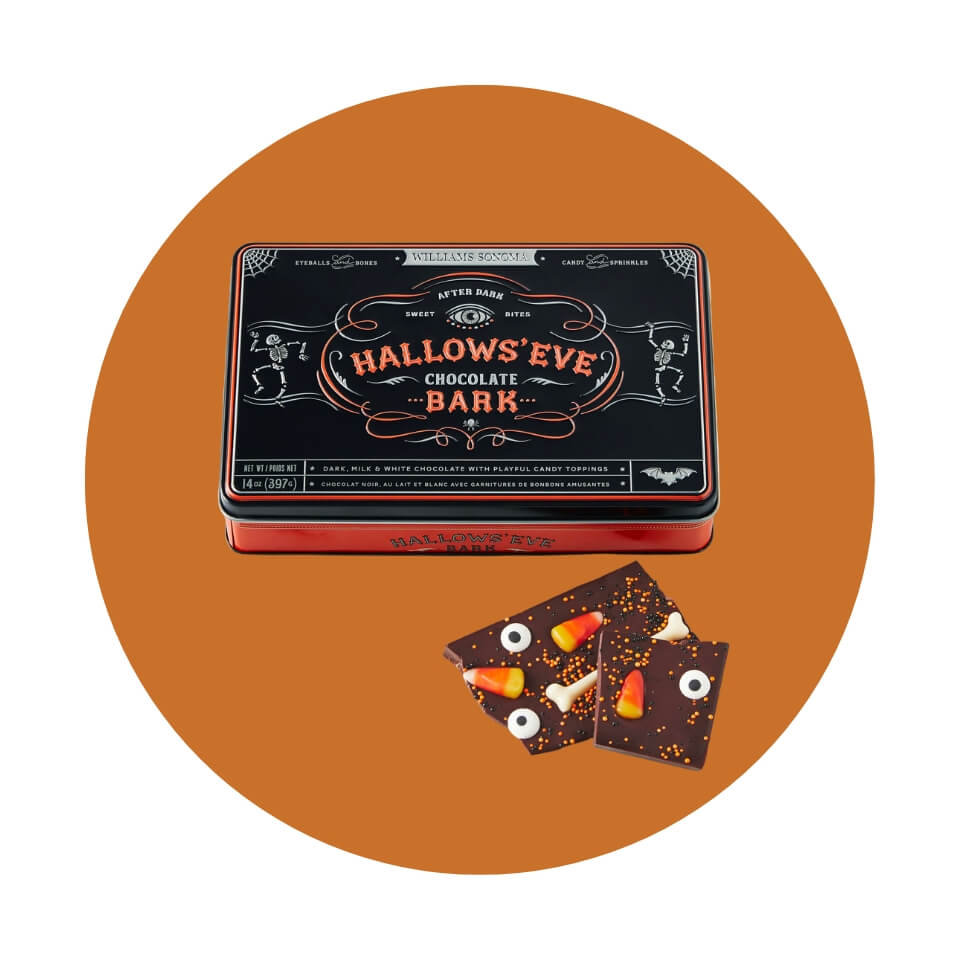 A black box and some chocolate candy bark on an orange circle