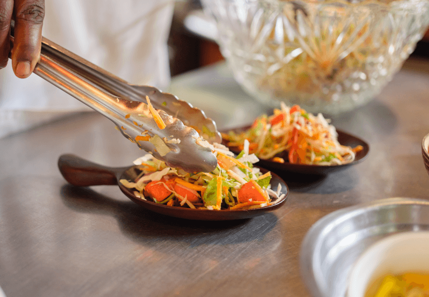 Person serving food into little dishes