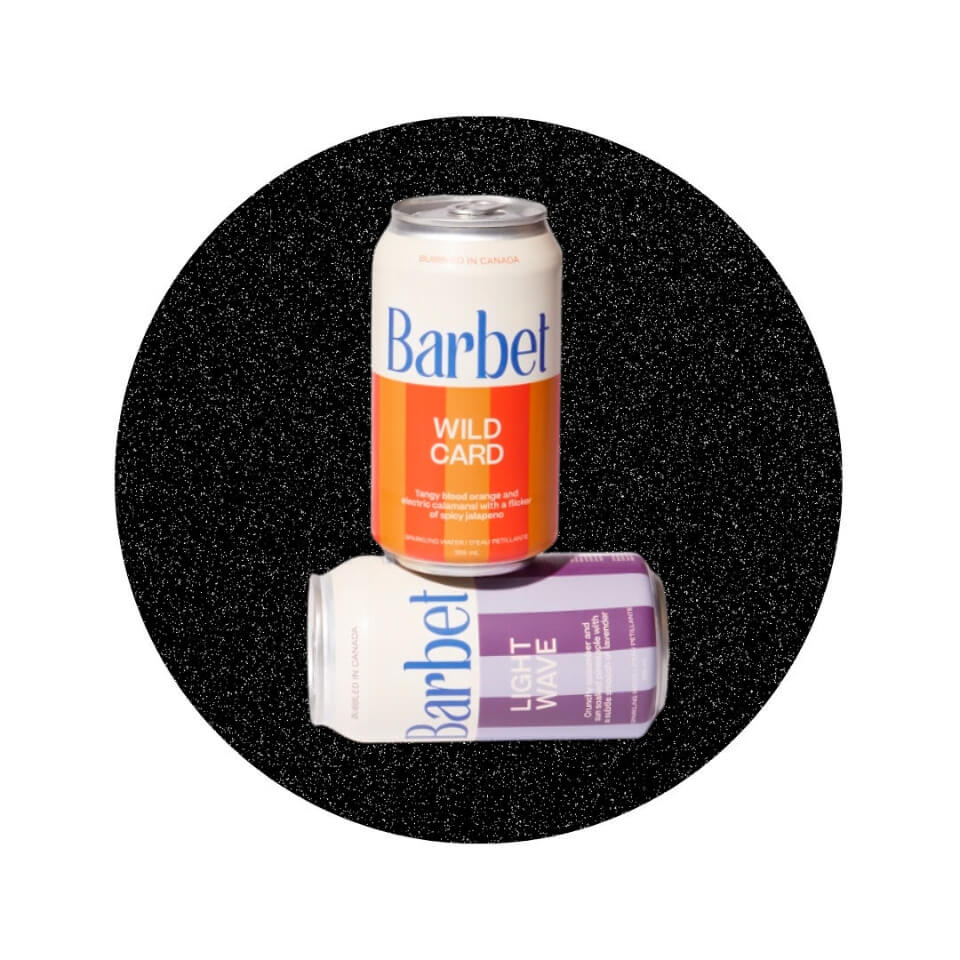 Two cans with colourful striped labels in a sparkly black circle