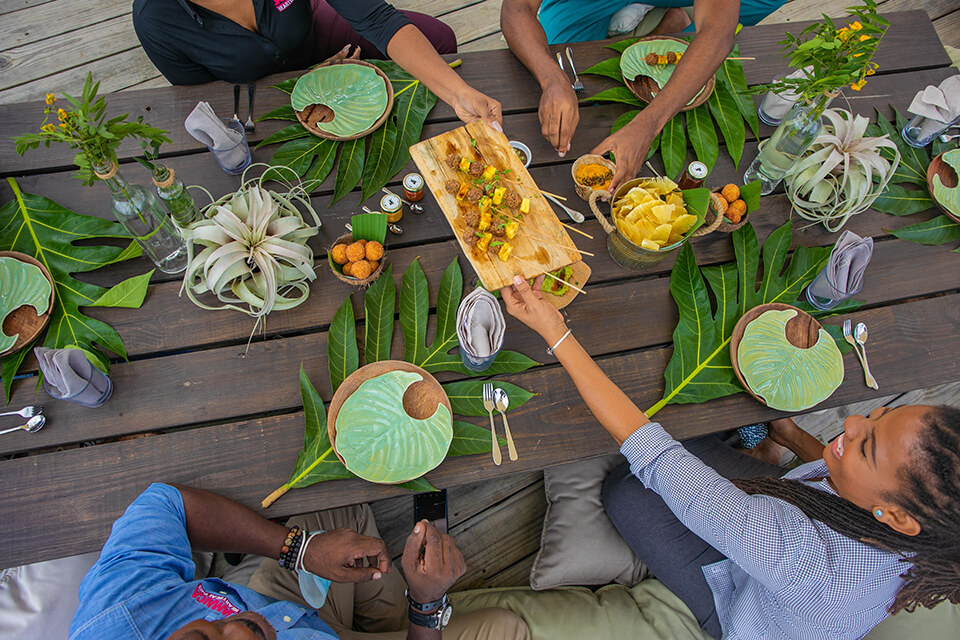 People sharing food at an outdoor picnic table