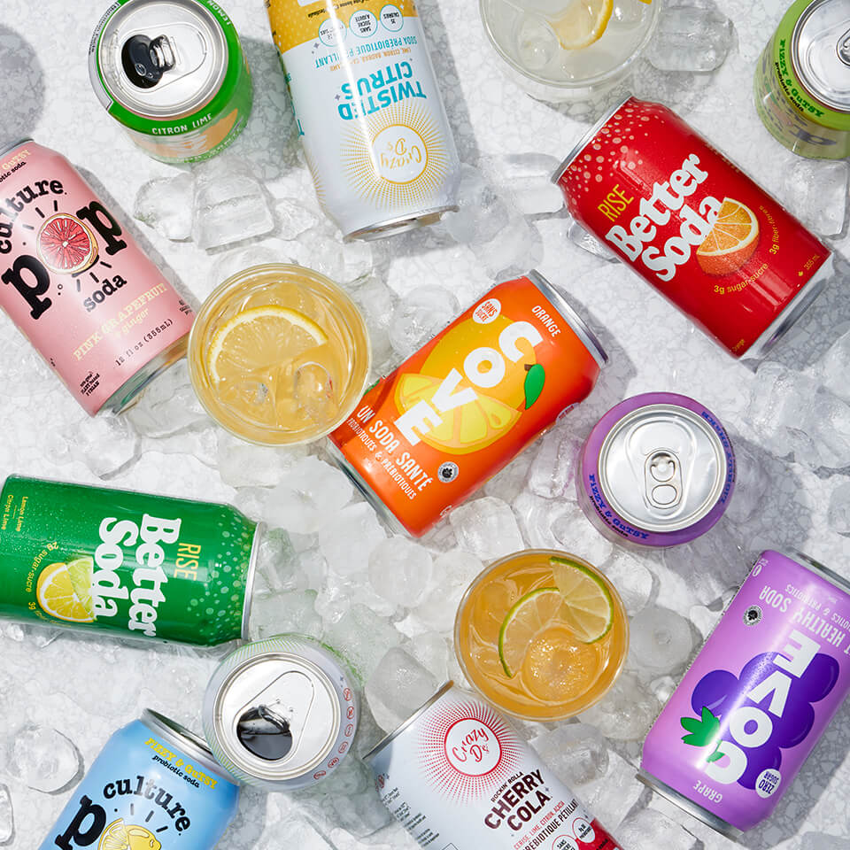 Various cans of soda scattered amongst ice