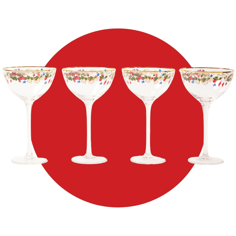 Four coupe glasses with colourful rims over a red circle