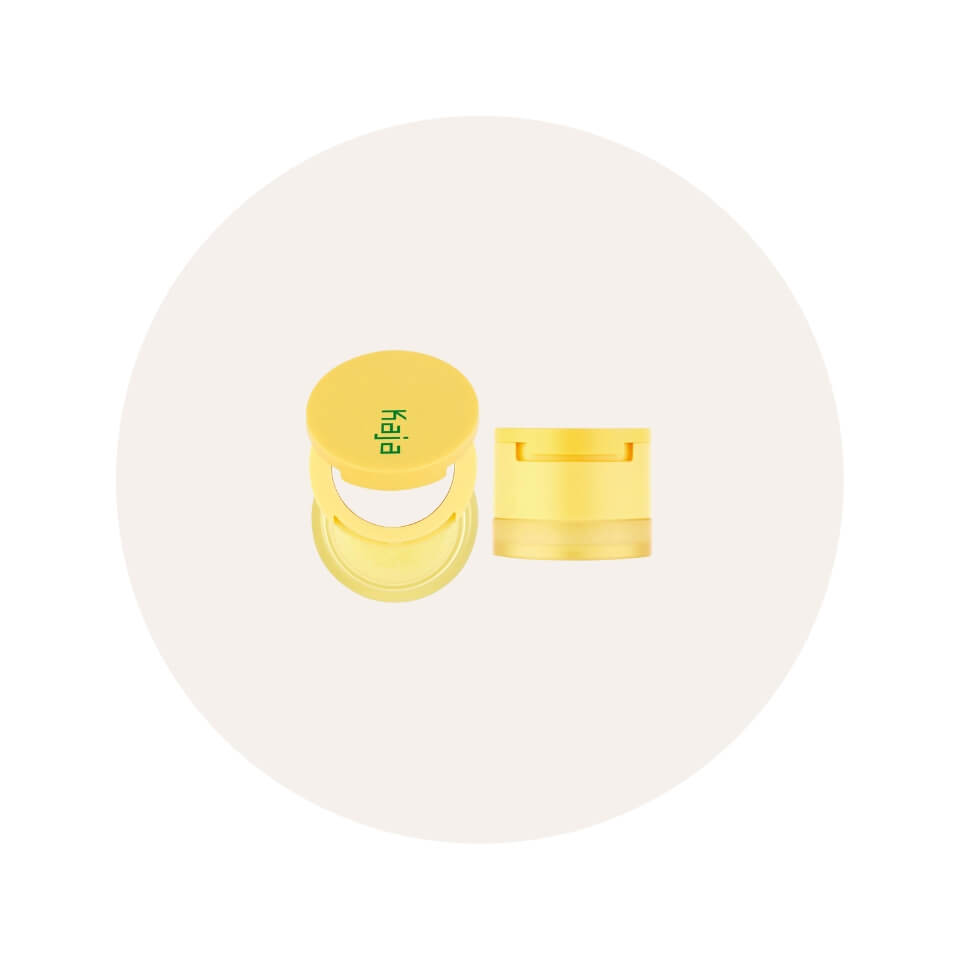 A yellow tiered lip product in a cream-coloured circle