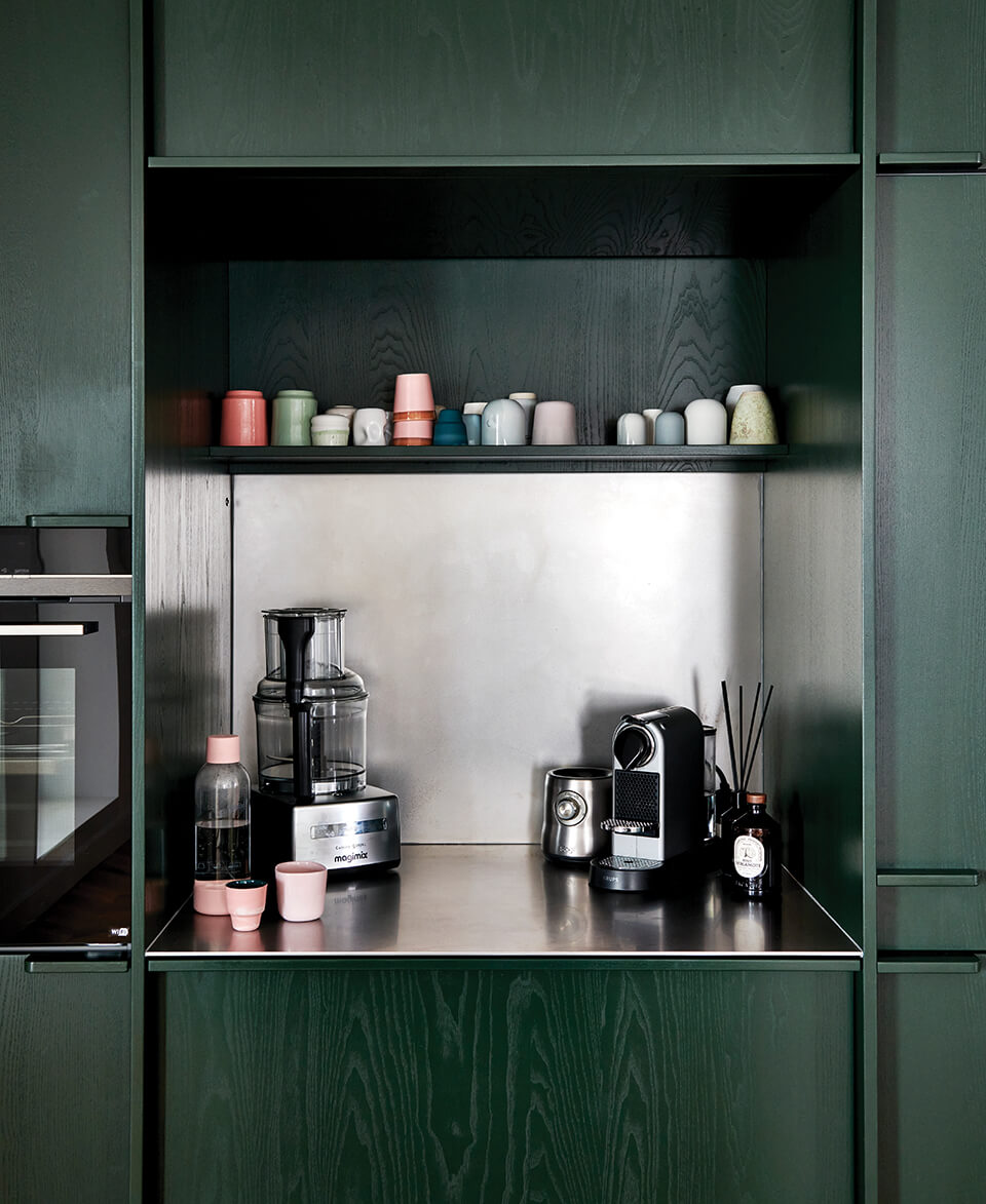 A home coffee bar with dark green panelling