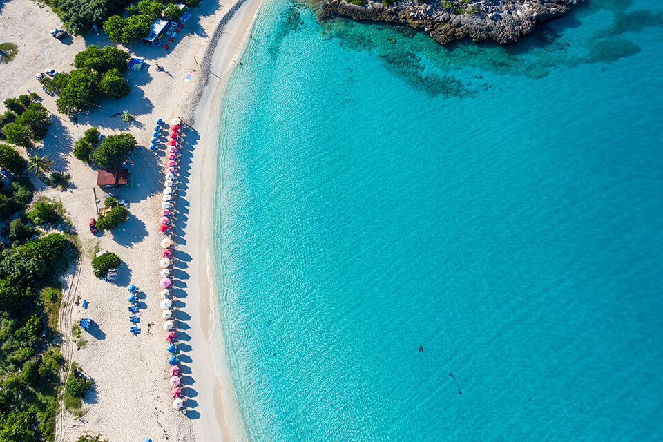 Overhead image of turquoise water and beach