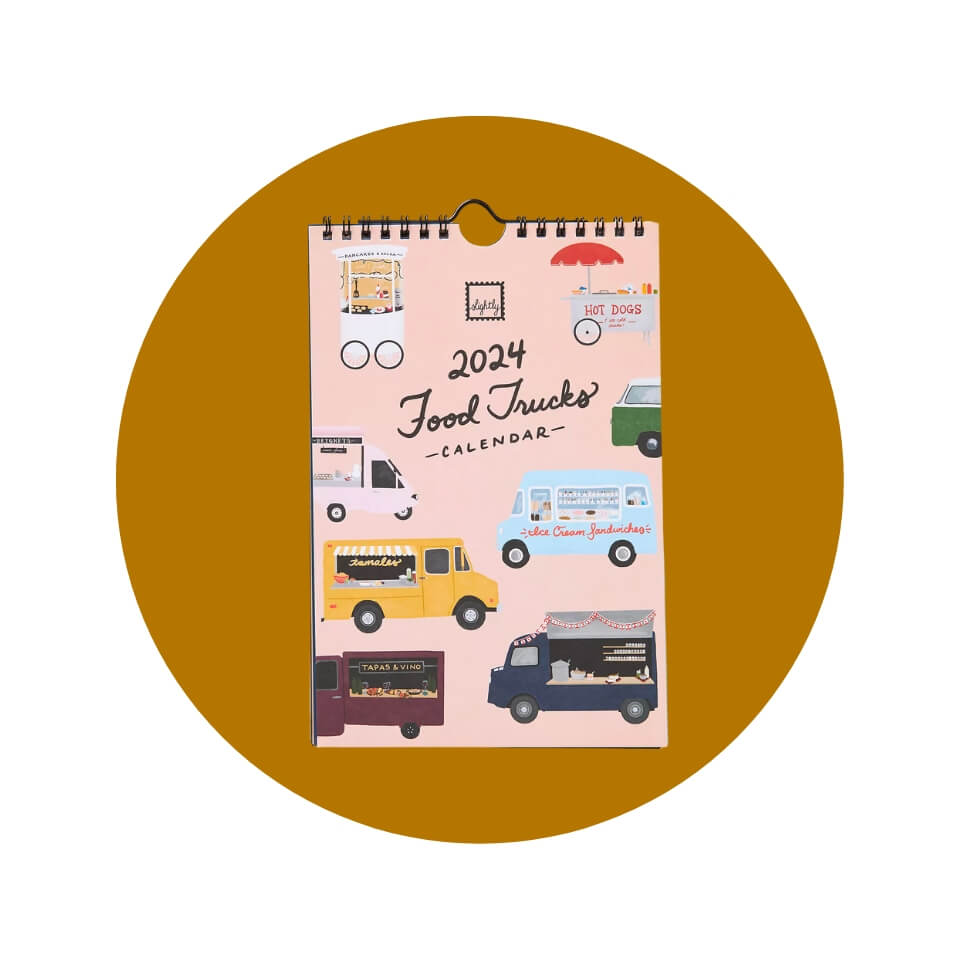 A pink desk calendar with different food trucks on the cover inside a gold-brown circle