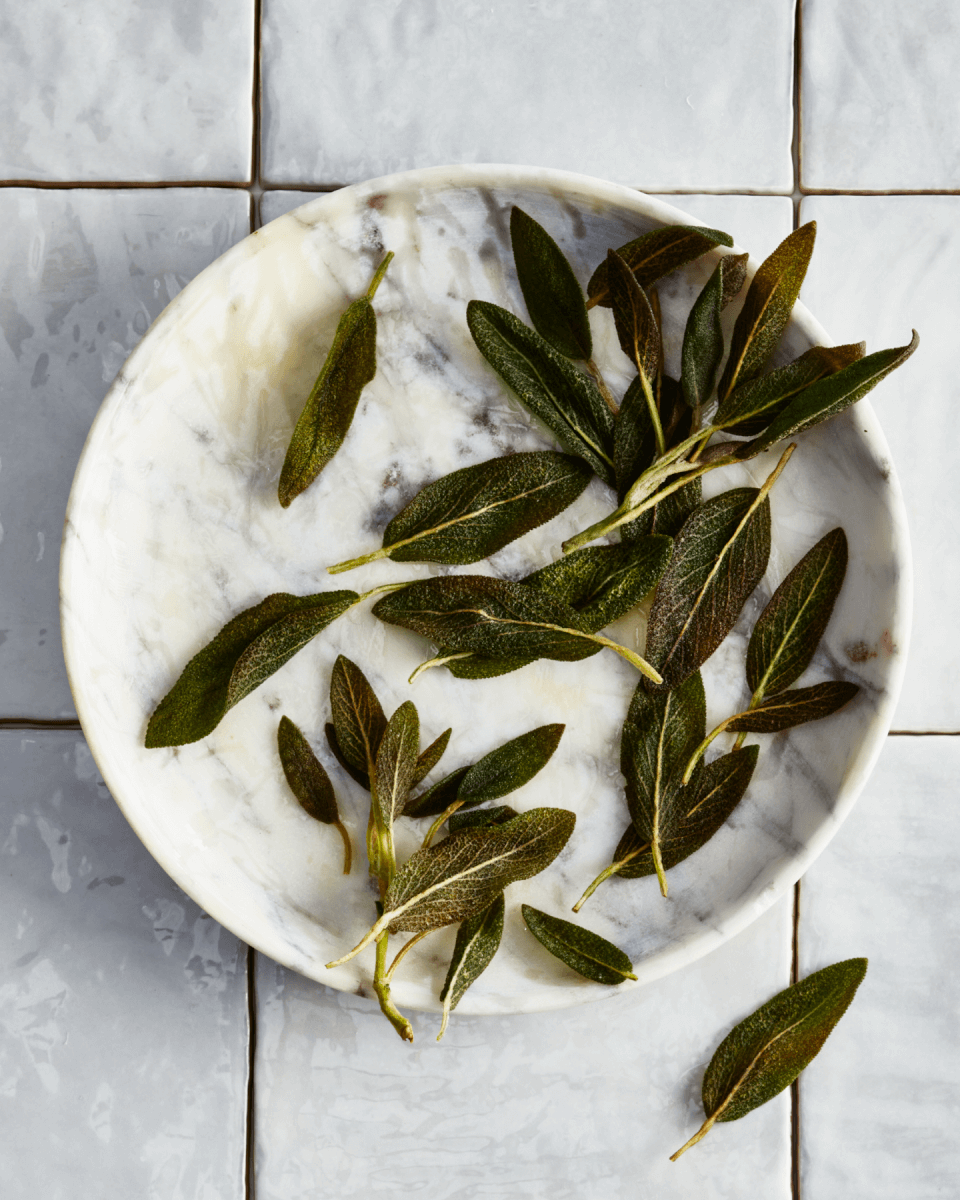 white plate with sage leaves