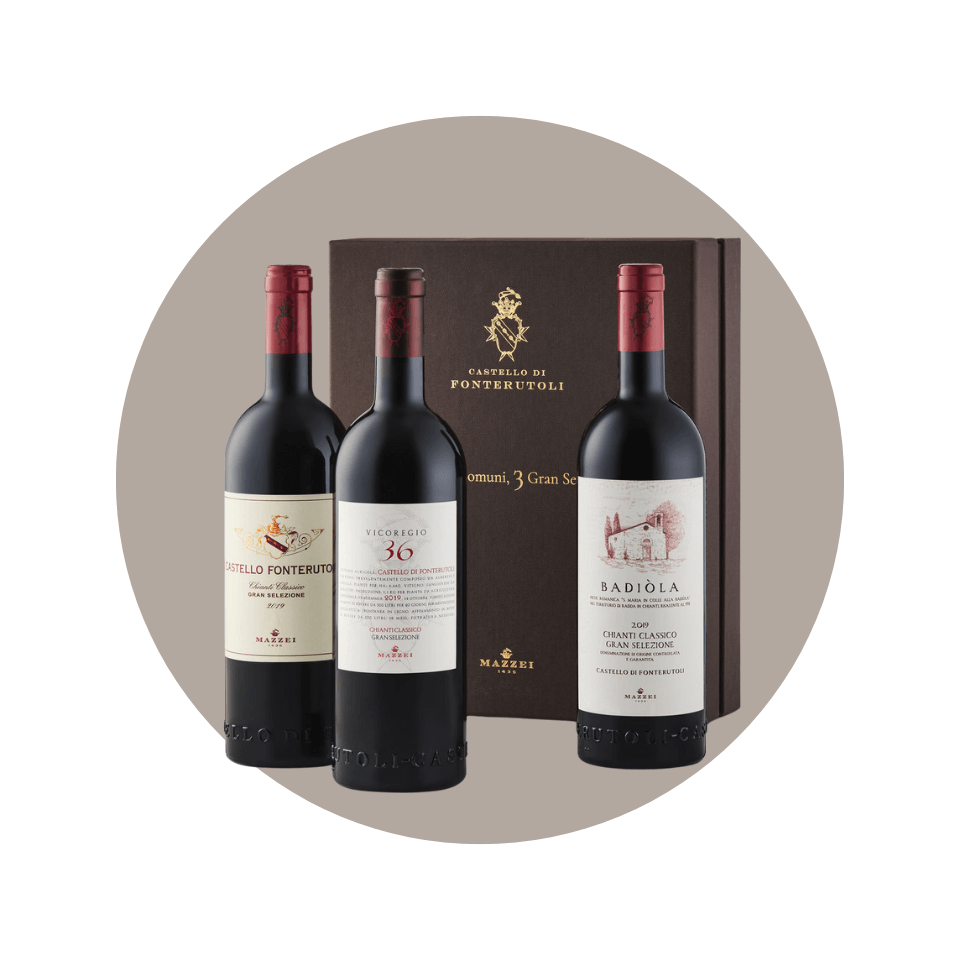 three bottles of red wine in front of box