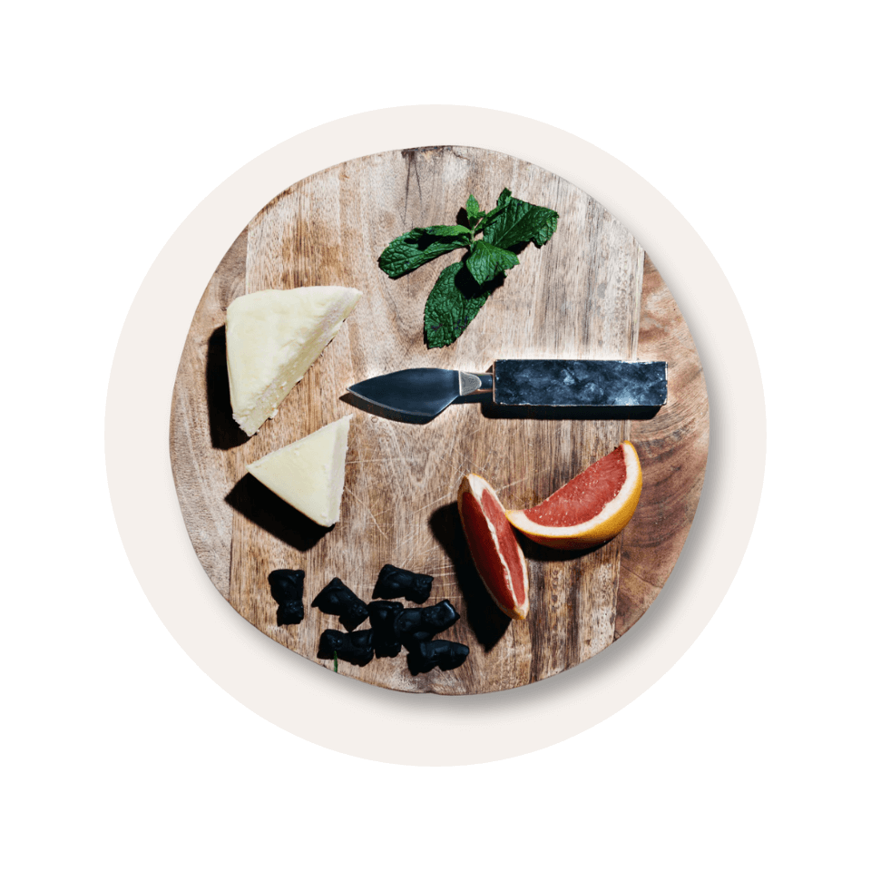 Wooden cheeseboard with cheese and knife