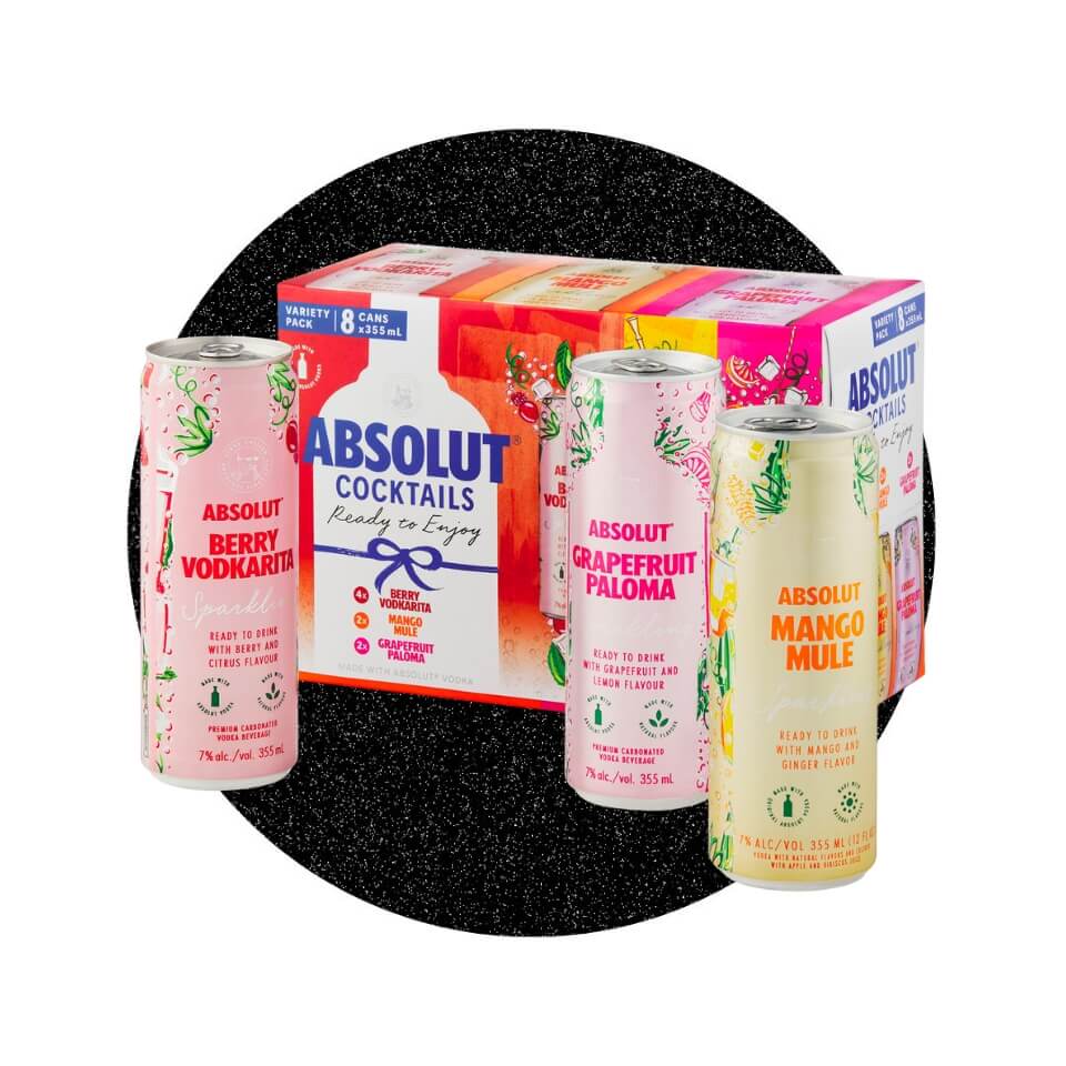 Three coloured cans and a holiday-themed box over a sparkly black circle