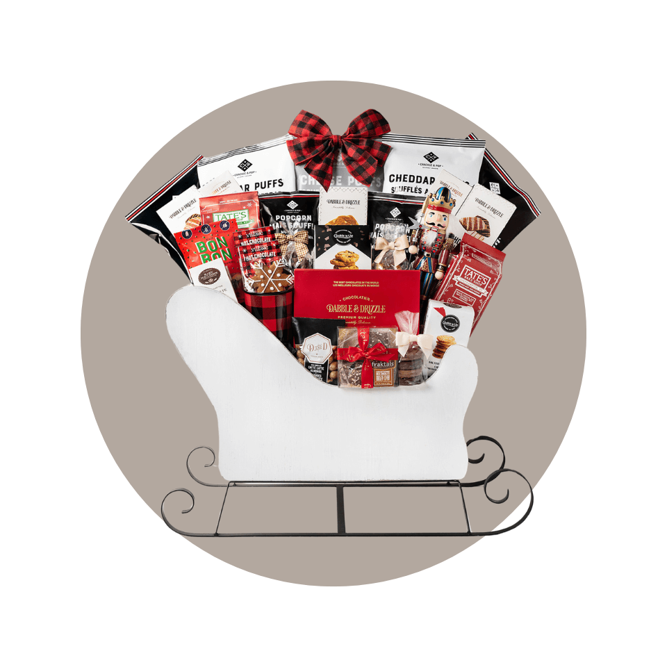 white wooden miniature sleigh stuffed with gift food