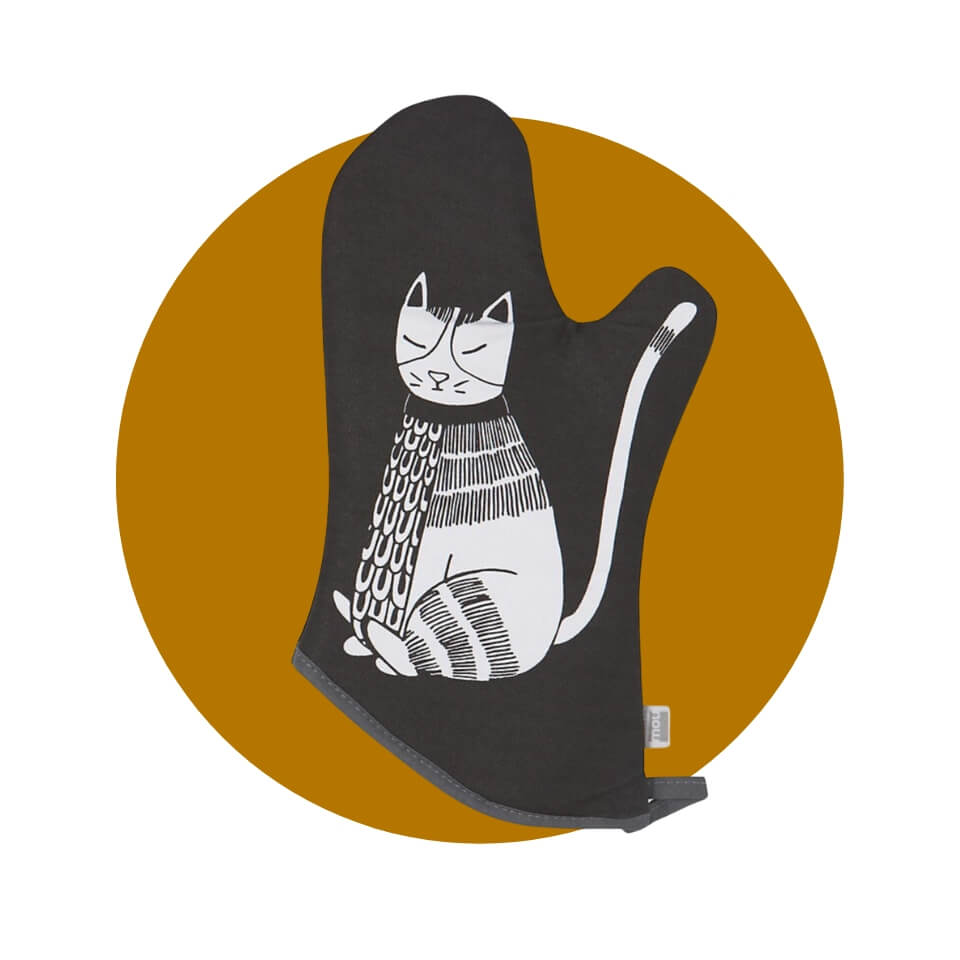 A black oven mitt with a white cat illustration over a brown-gold circle