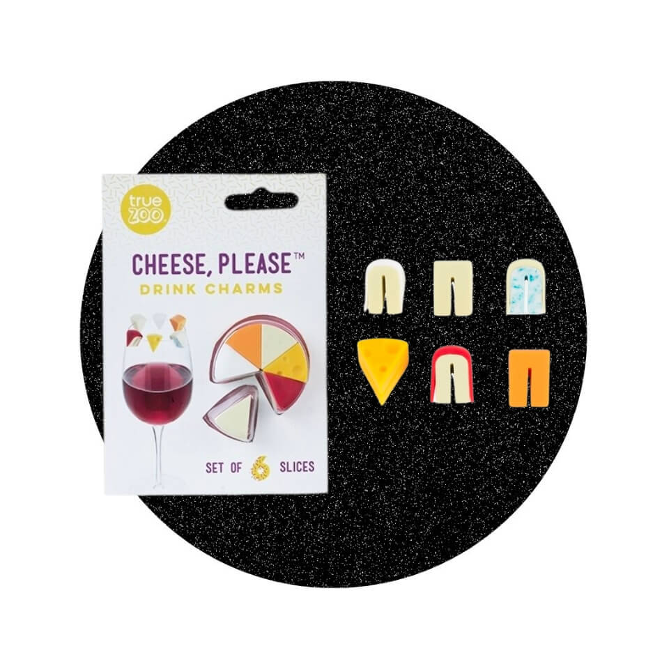A small white package and six miniature wedges of cheese in a sparkly black circle