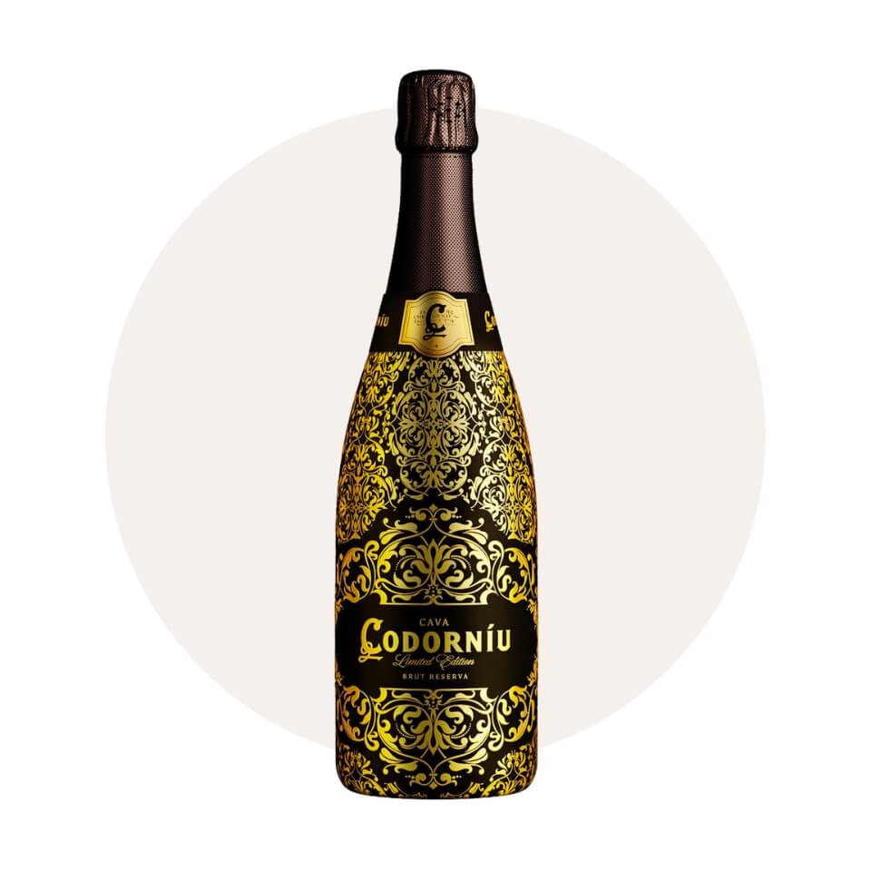 A black-and-gold sparkling wine bottle over a cream-coloured circle
