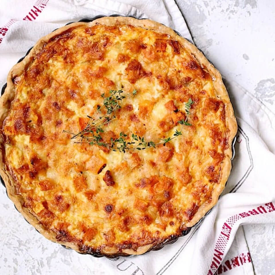 A tart on top of a countertop with a tea towel