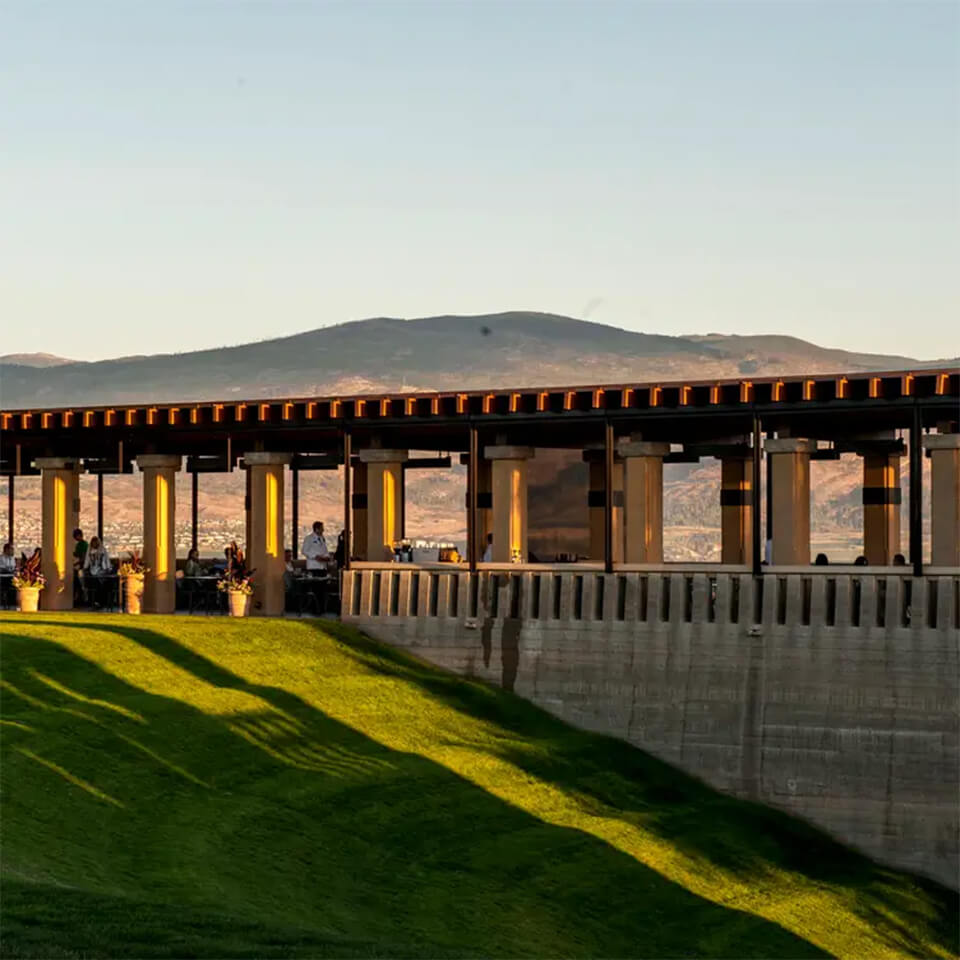 Landscape view of mountain through an outdoor terrace with people dining