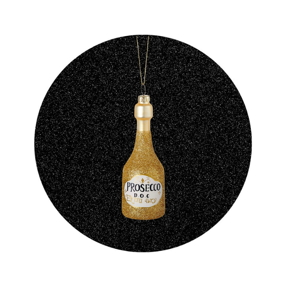 A Christmas tree ornament shaped like a gold bottle of Prosecco in a sparkly black circle