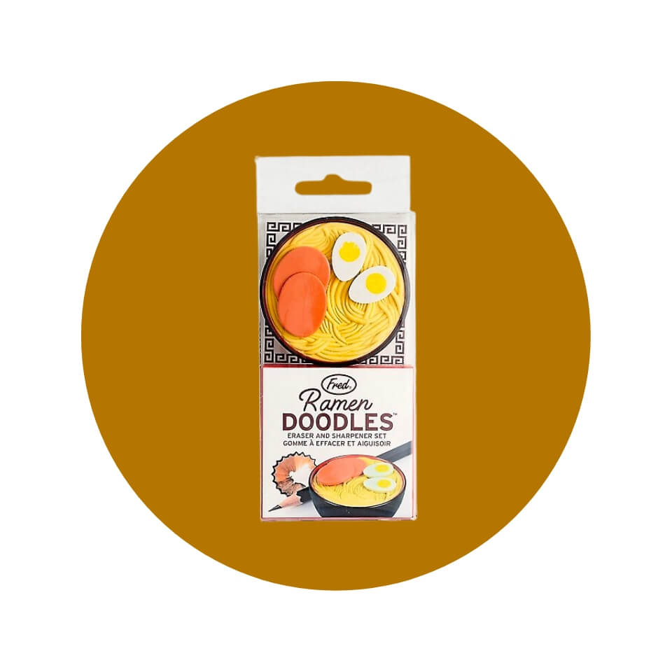 A box with a small bowl of ramen in a gold-brown circle