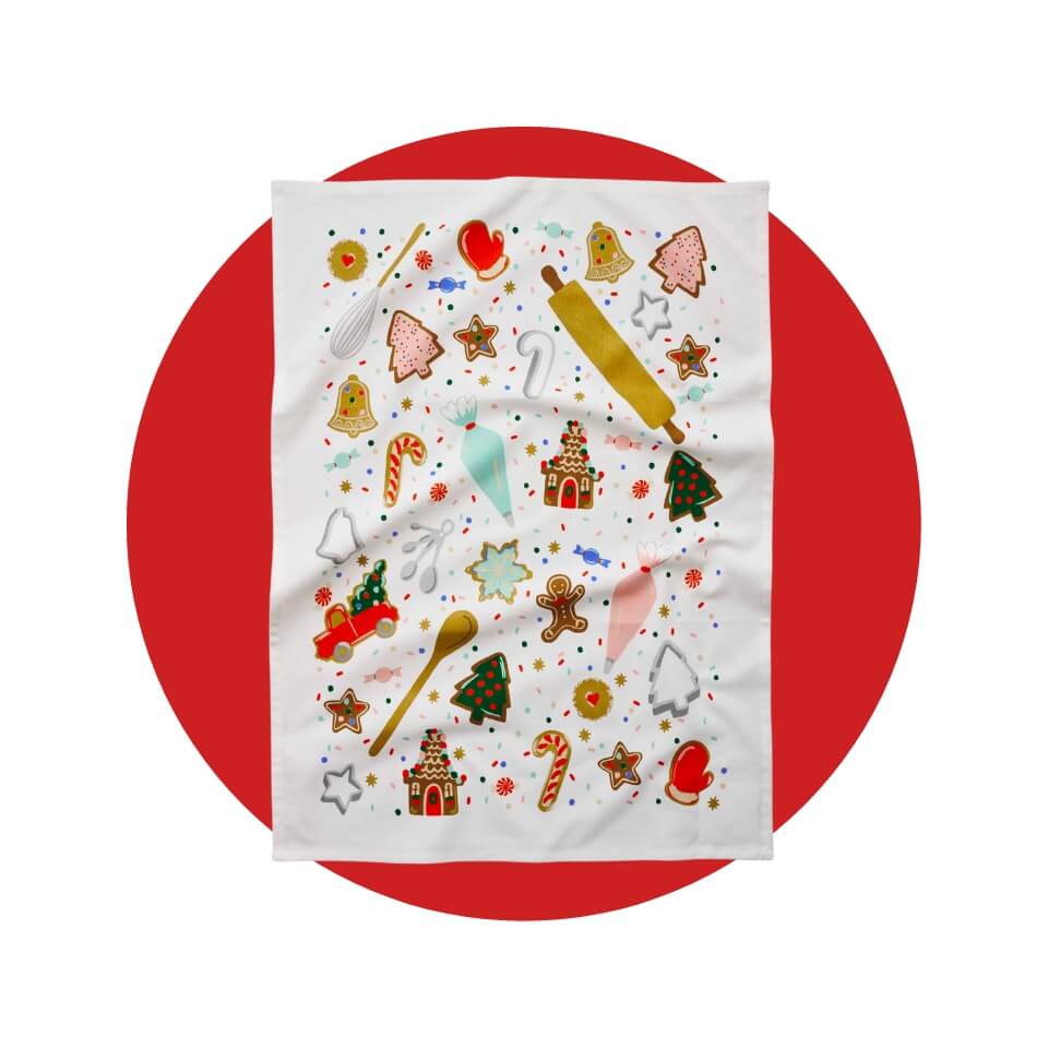 A white tea towel with Christmas cookies over a red circle