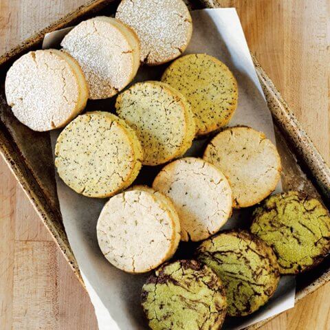 A tray with four rows of various shortbread cookies