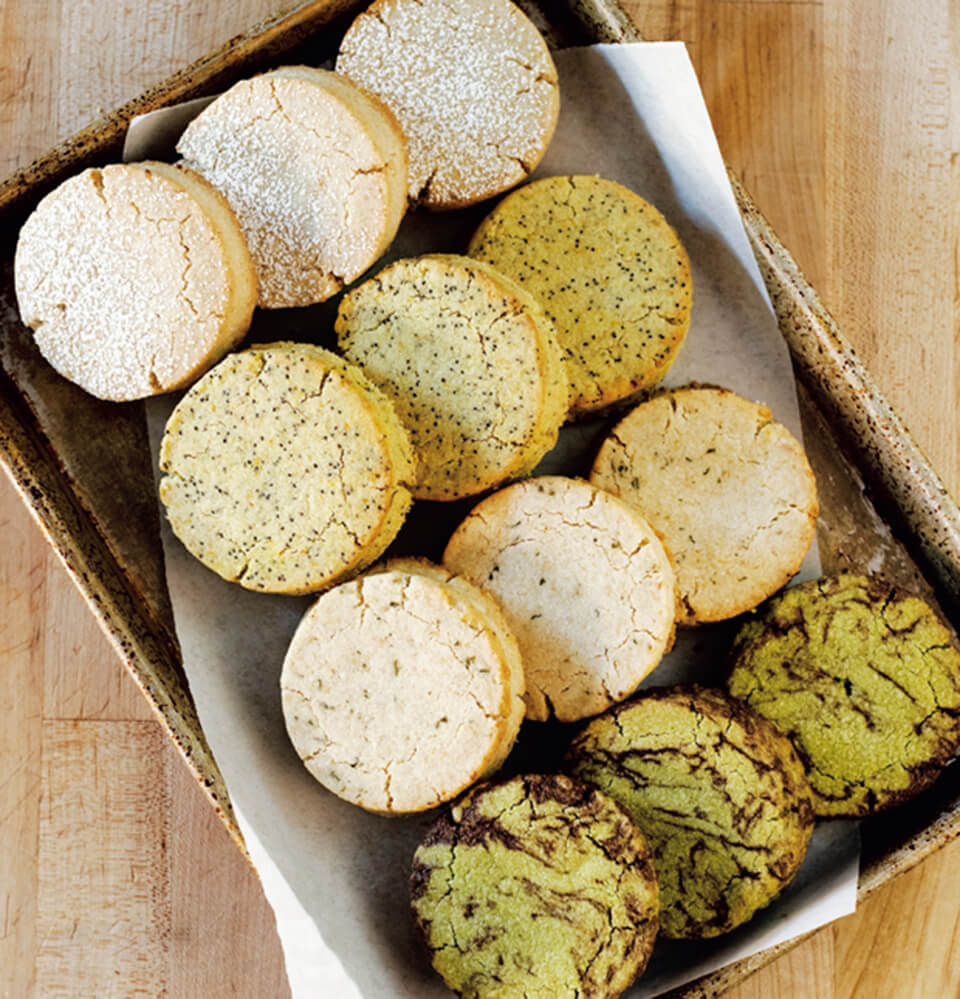 A tray with four rows of various shortbread cookies
