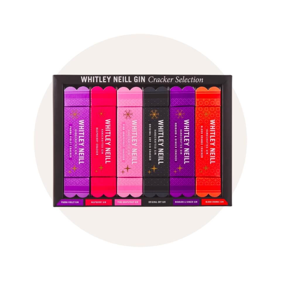 A black box of Christmas crackers in shades of red, pink, purple and black over a cream-coloured circle