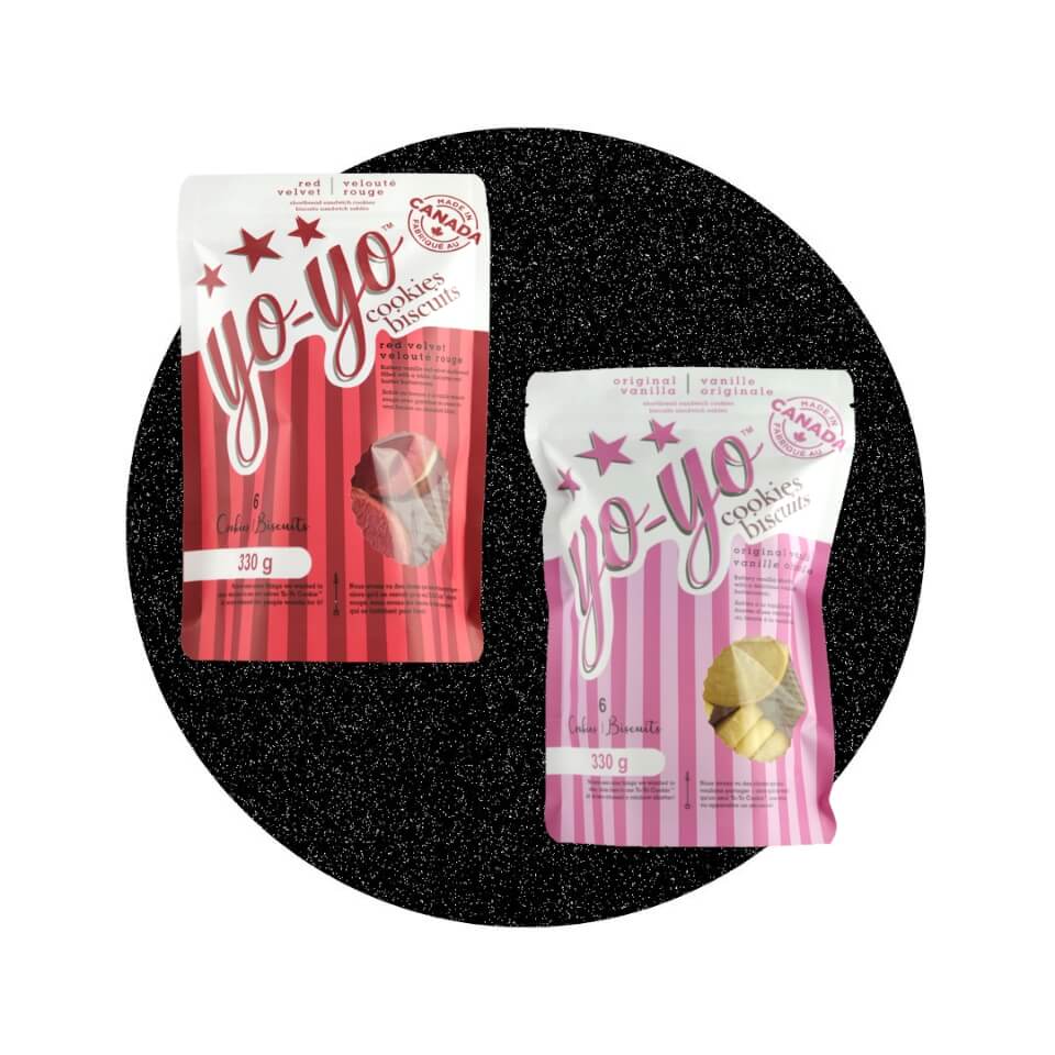 A red bag and a pink bag over a sparkly black circle