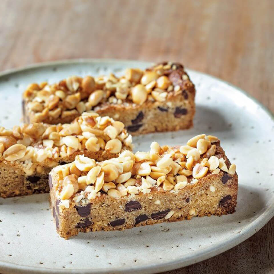 plate of blondies with peanut topping