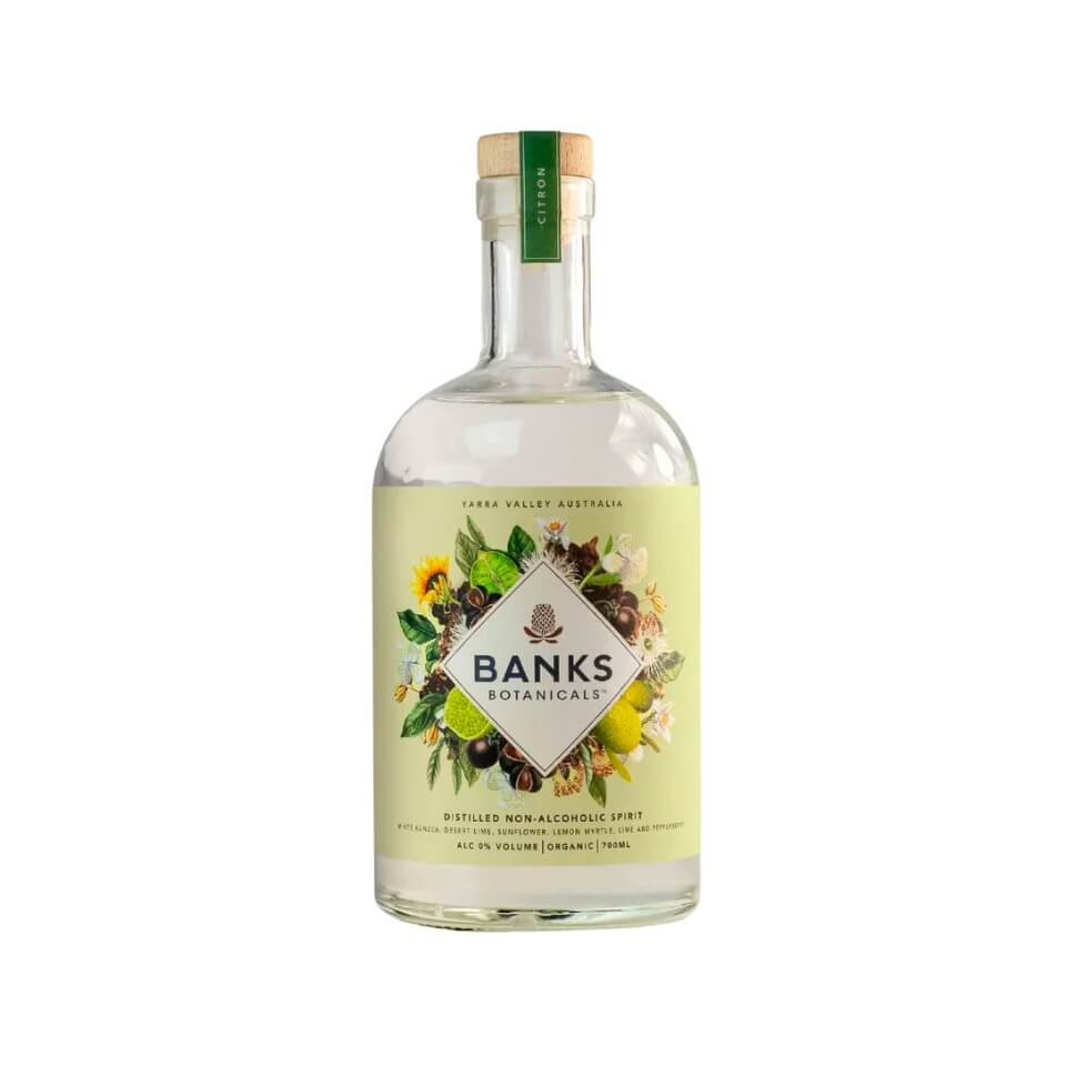 A bottle of clear spirits with a floral label