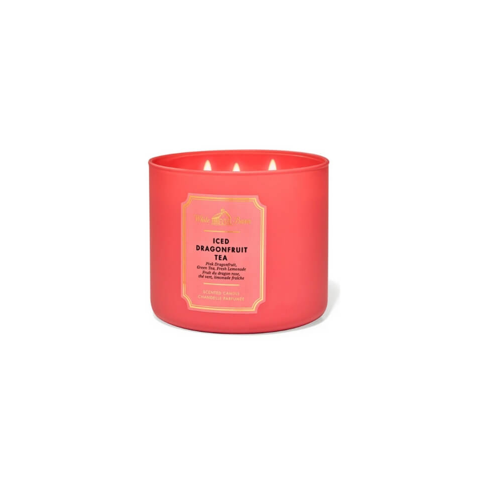 A coral-coloured candle with three wicks