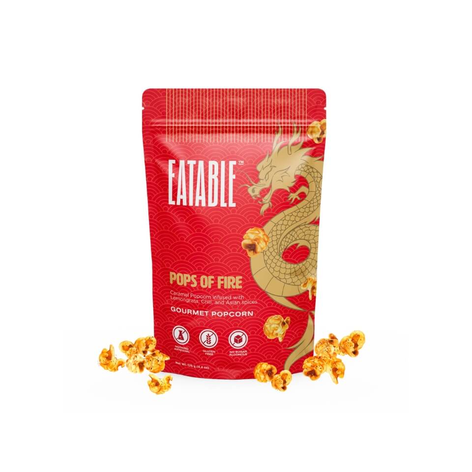 A red bag with a dragon on it and golden pieces of popcorn