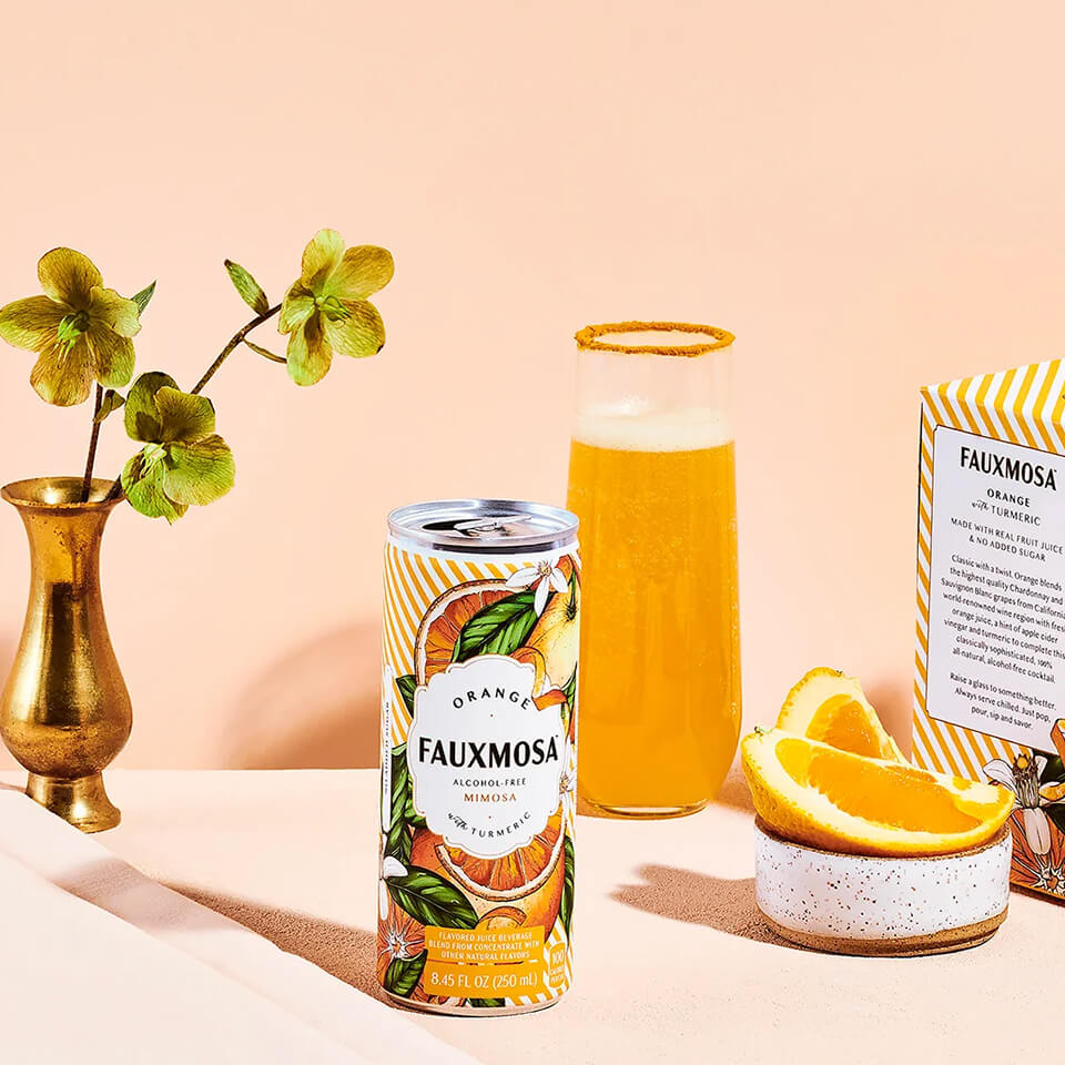 An orange can and mimosa with turmeric rim