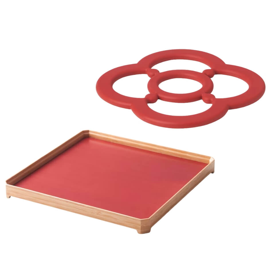 A red and light wood tray and a red trivet