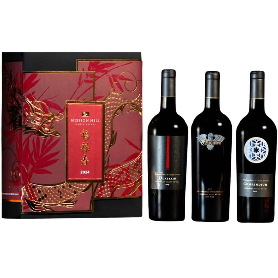 A red box with a dragon design and three bottles of wine
