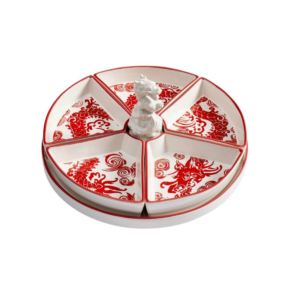 A rotating serving dish with a red and white dragon design