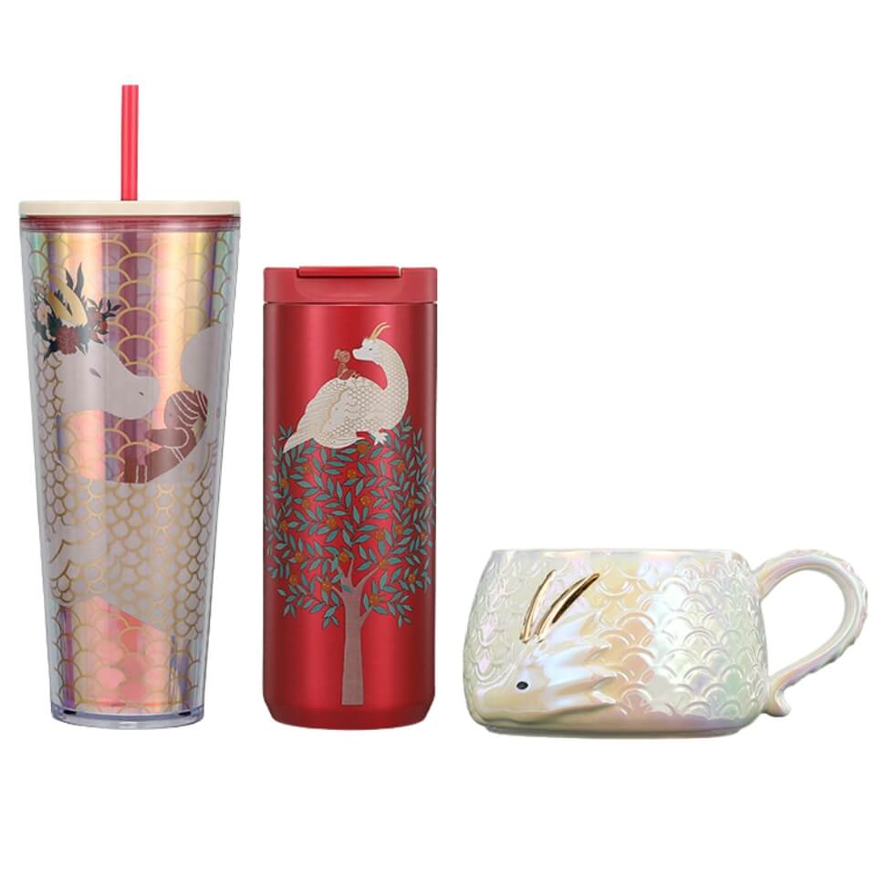 A mug and two tumblers decorated with a white dragon