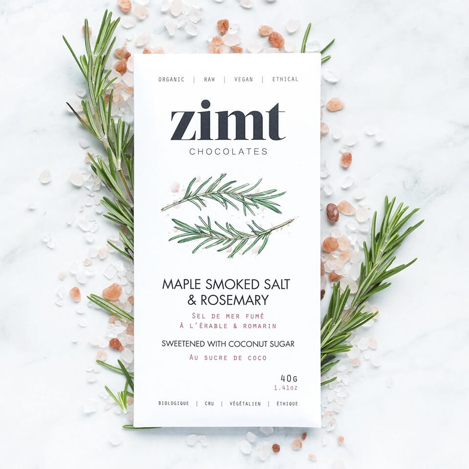 A white packaged bar on top of salt and rosemary