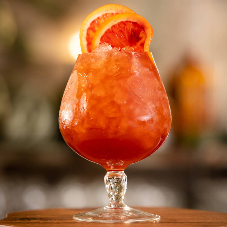 A cocktail with a blood orange garnish