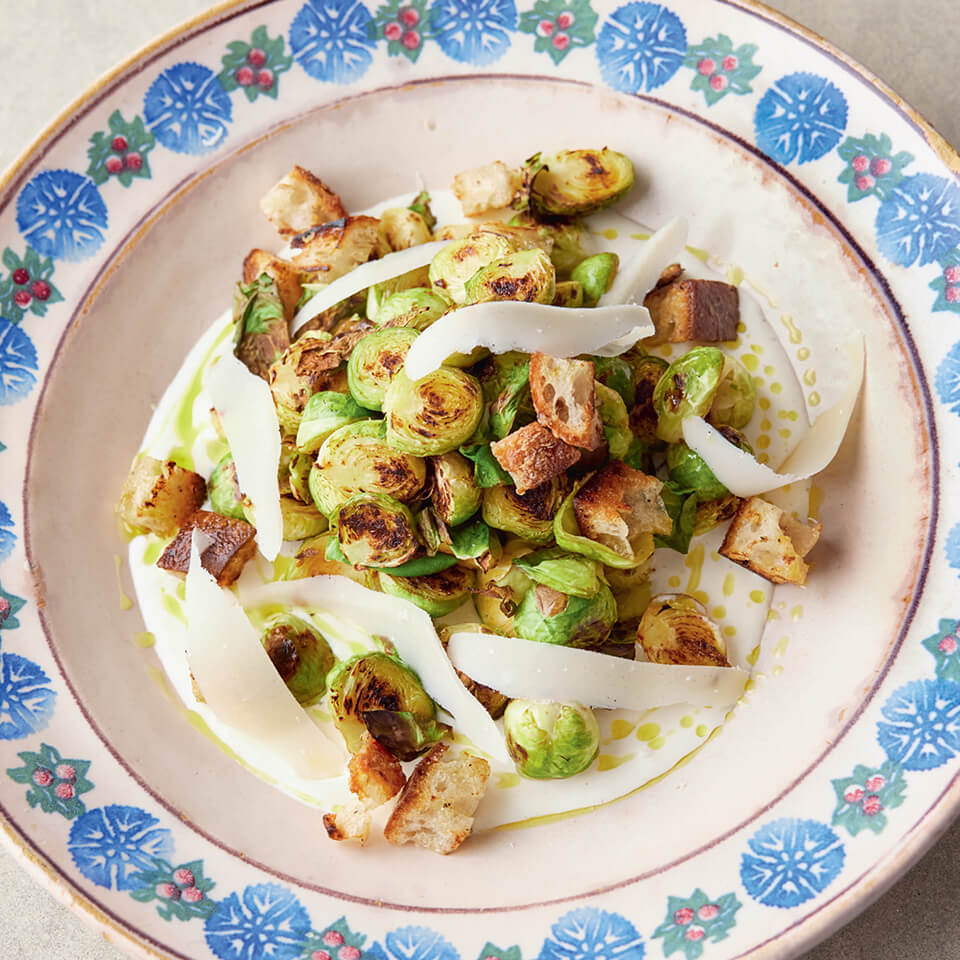 A patterned dish with roasted Brussels sprouts