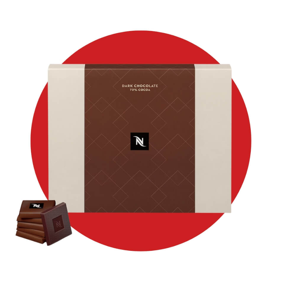 A box and a few chocolates in front of a red circle