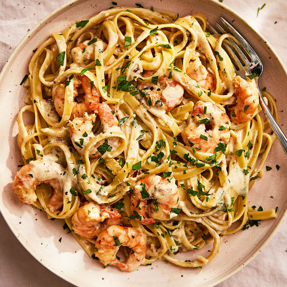 A dish with shrimp and pasta