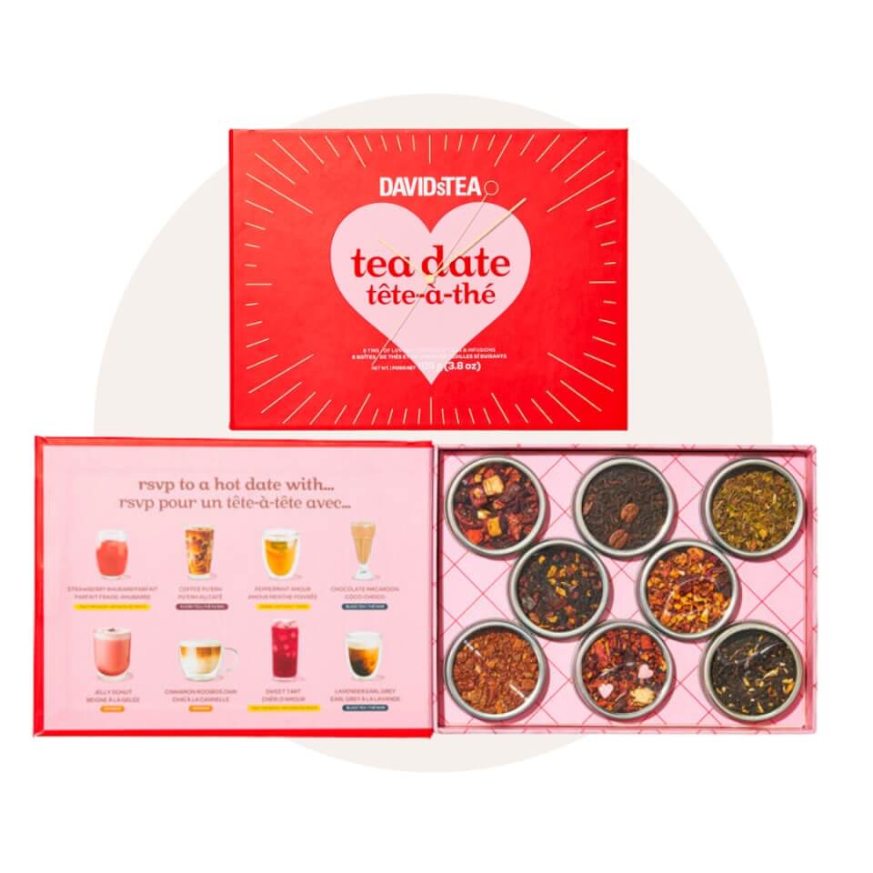 A red and pink box of miniature cansters with tea