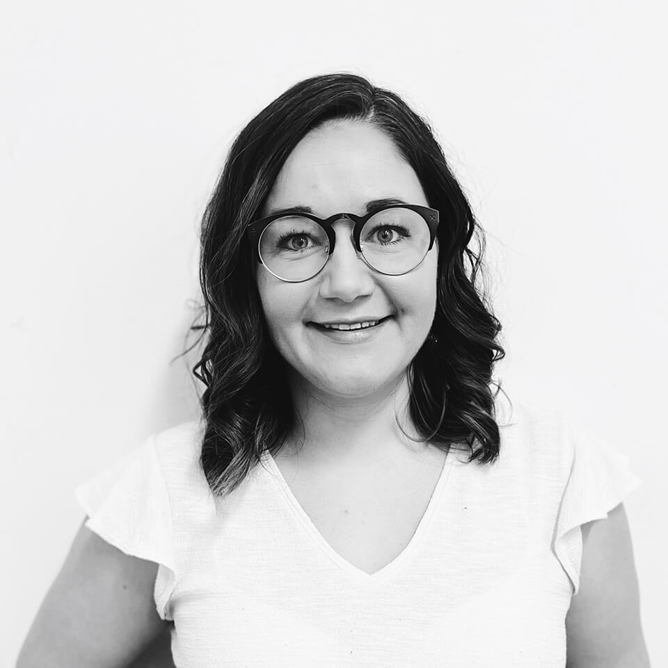 A woman, Caitlin Quinn, smiles at the camera