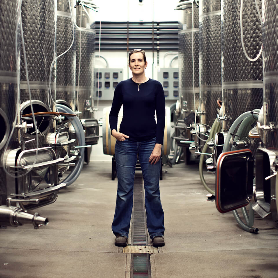 A woman, Severine Pinte, stands in a room filled with metal vats