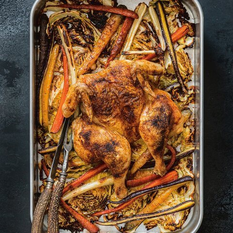 A silver sheet-pan with chicken and vegetables
