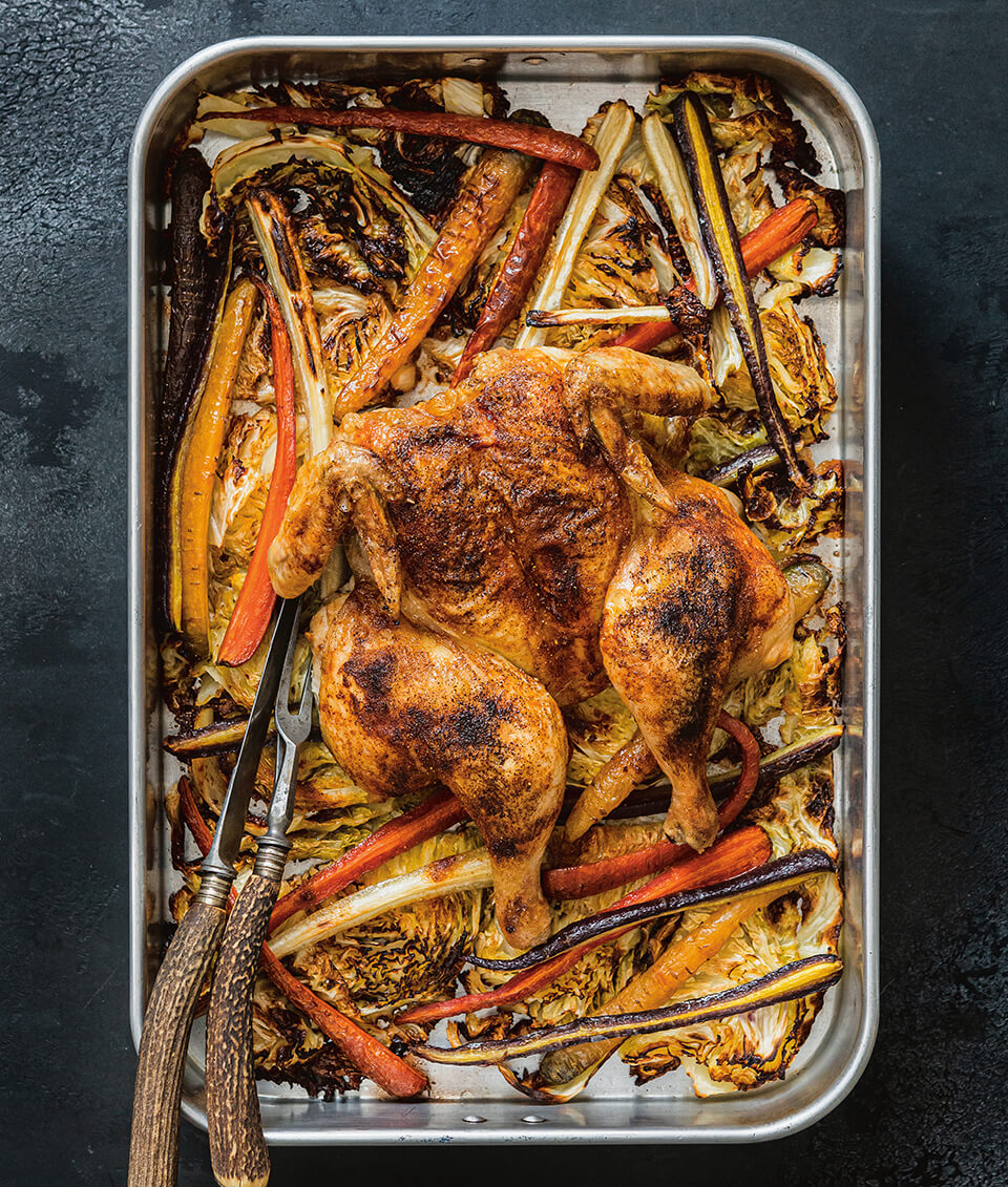 A silver sheet-pan with chicken and vegetables