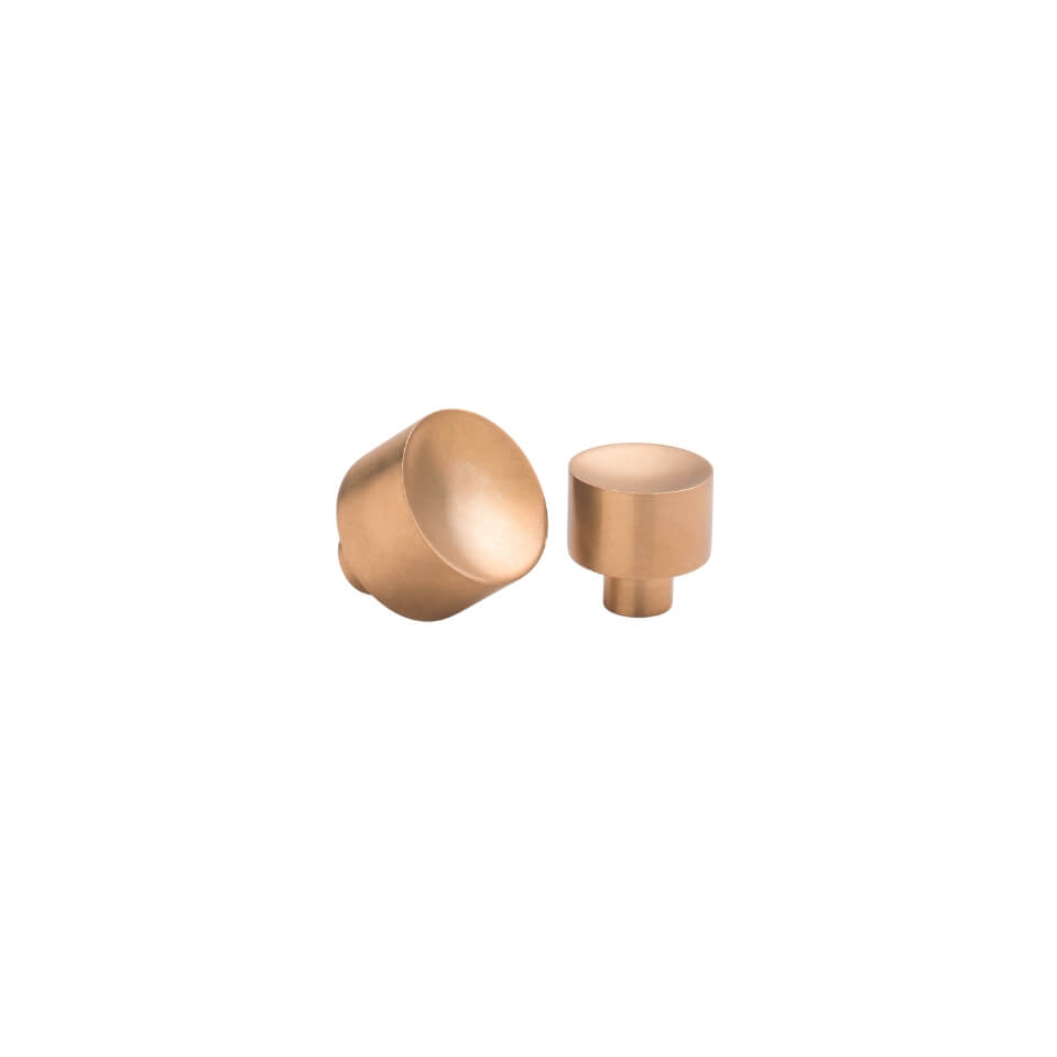 Two brass drawer knobs in slightly differing sizes